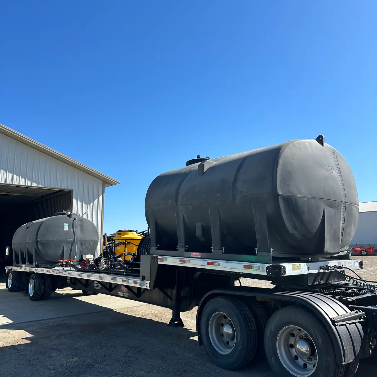 Custom-built nurse trailer with a large black poly tank on a semi flatbed at Dahl Farm Supply